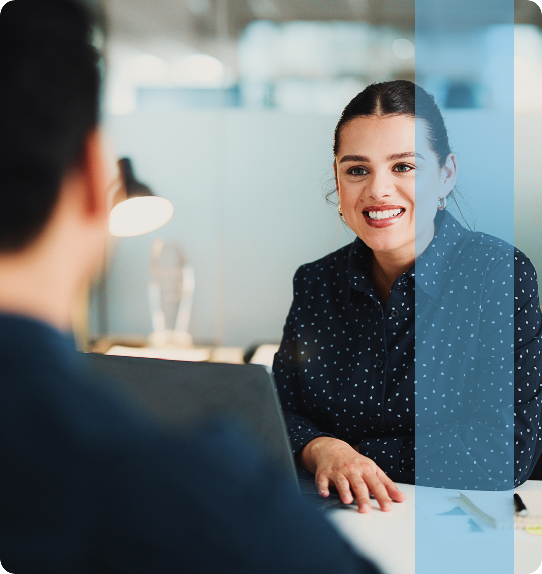 A smiling corporate female reviewing data sheets representing the Konnekt Finance and Legal recruitment team.