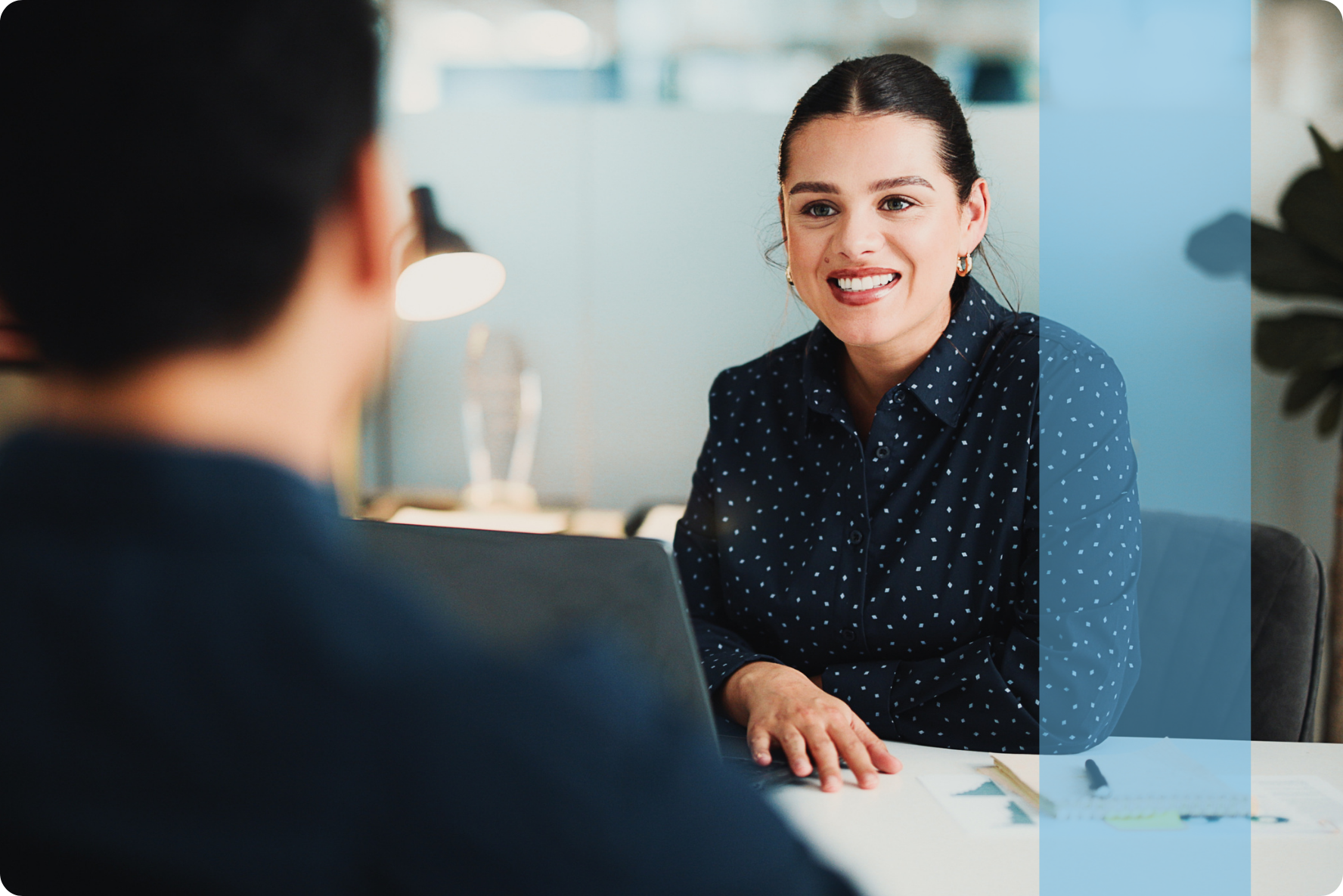 A smiling corporate female reviewing data sheets representing the Konnekt Finance and Legal recruitment team.