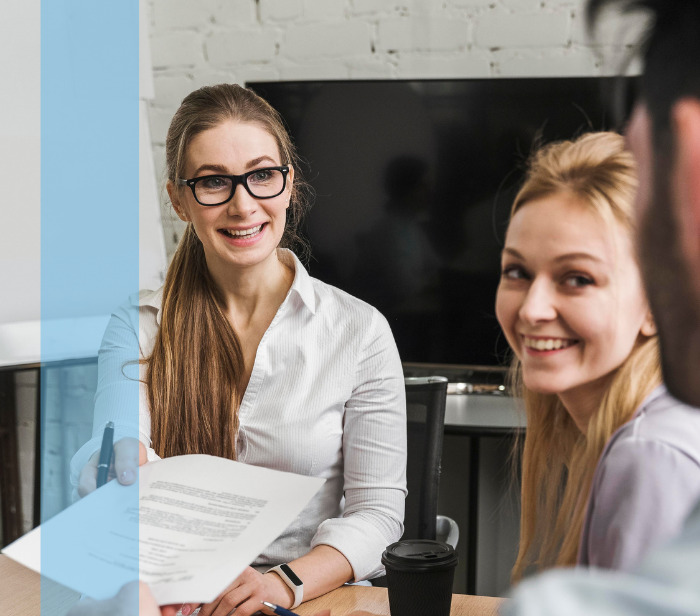 A group of business professionals collaborating around a table, representing Konnekt's responsive recruitment solutions.