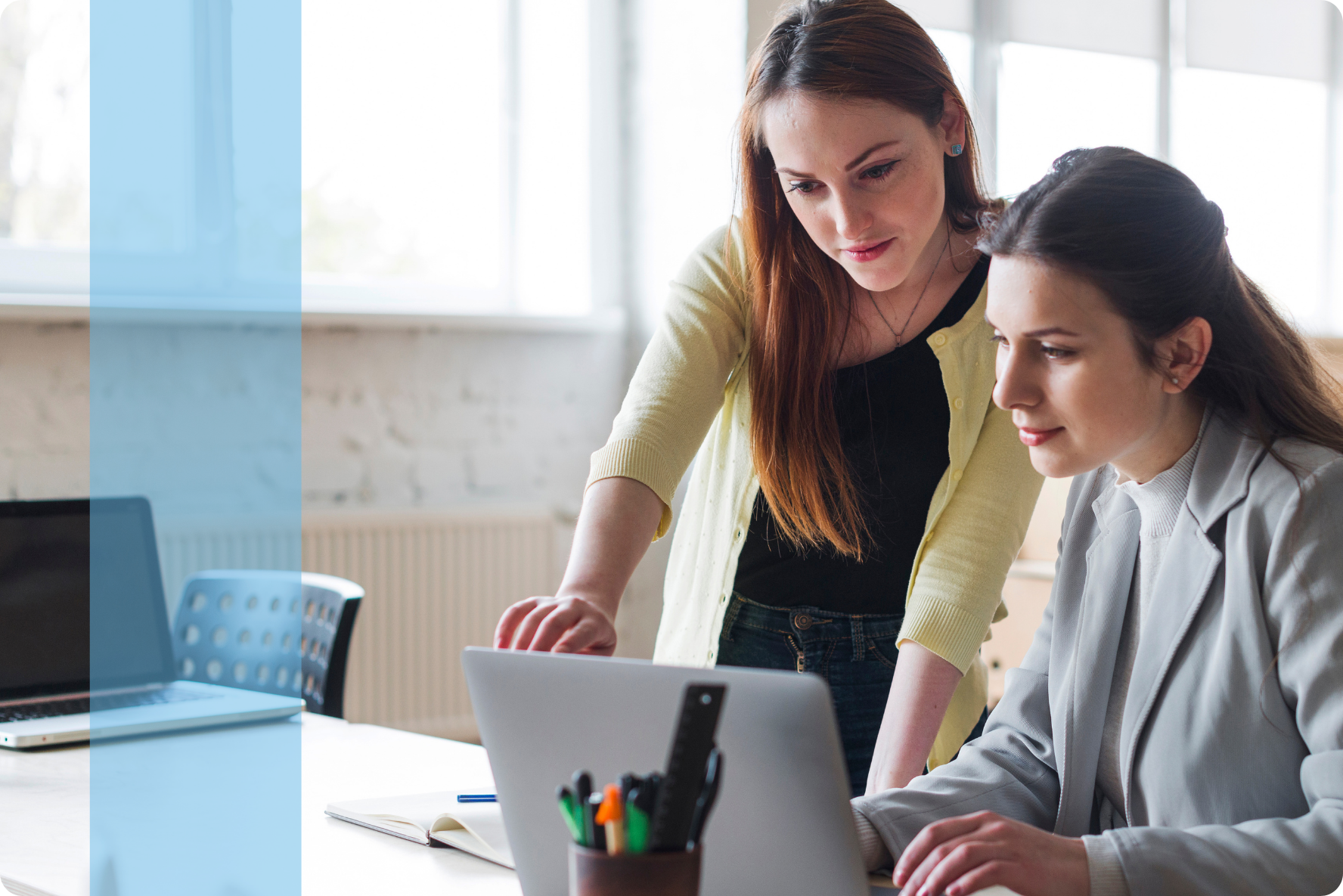 Two employees discussing in front of a laptop representing the Konnekt Generalist recruitment team.