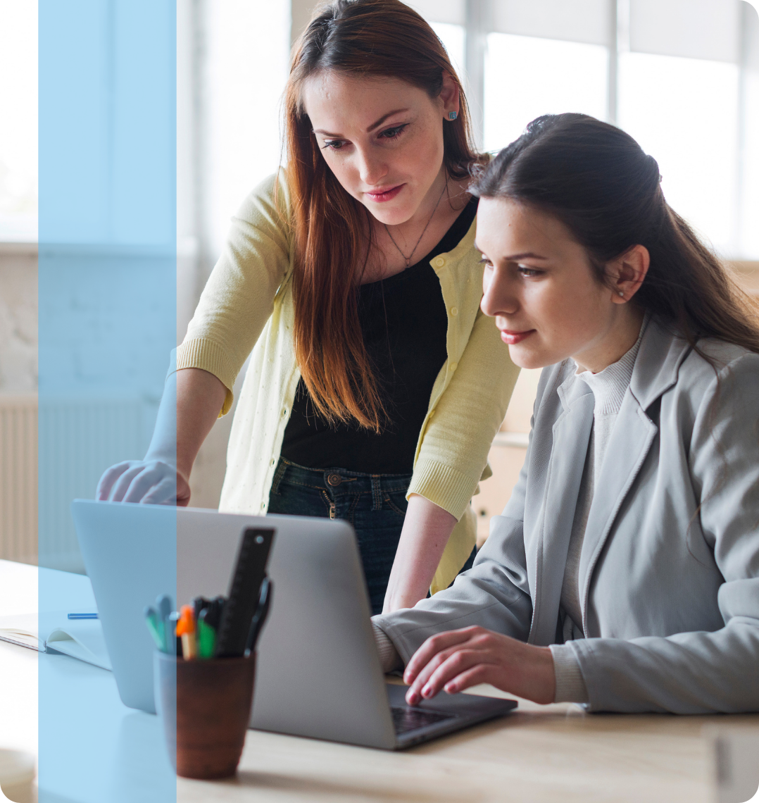 Two employees discussing in front of a laptop representing the Konnekt Generalist recruitment team.