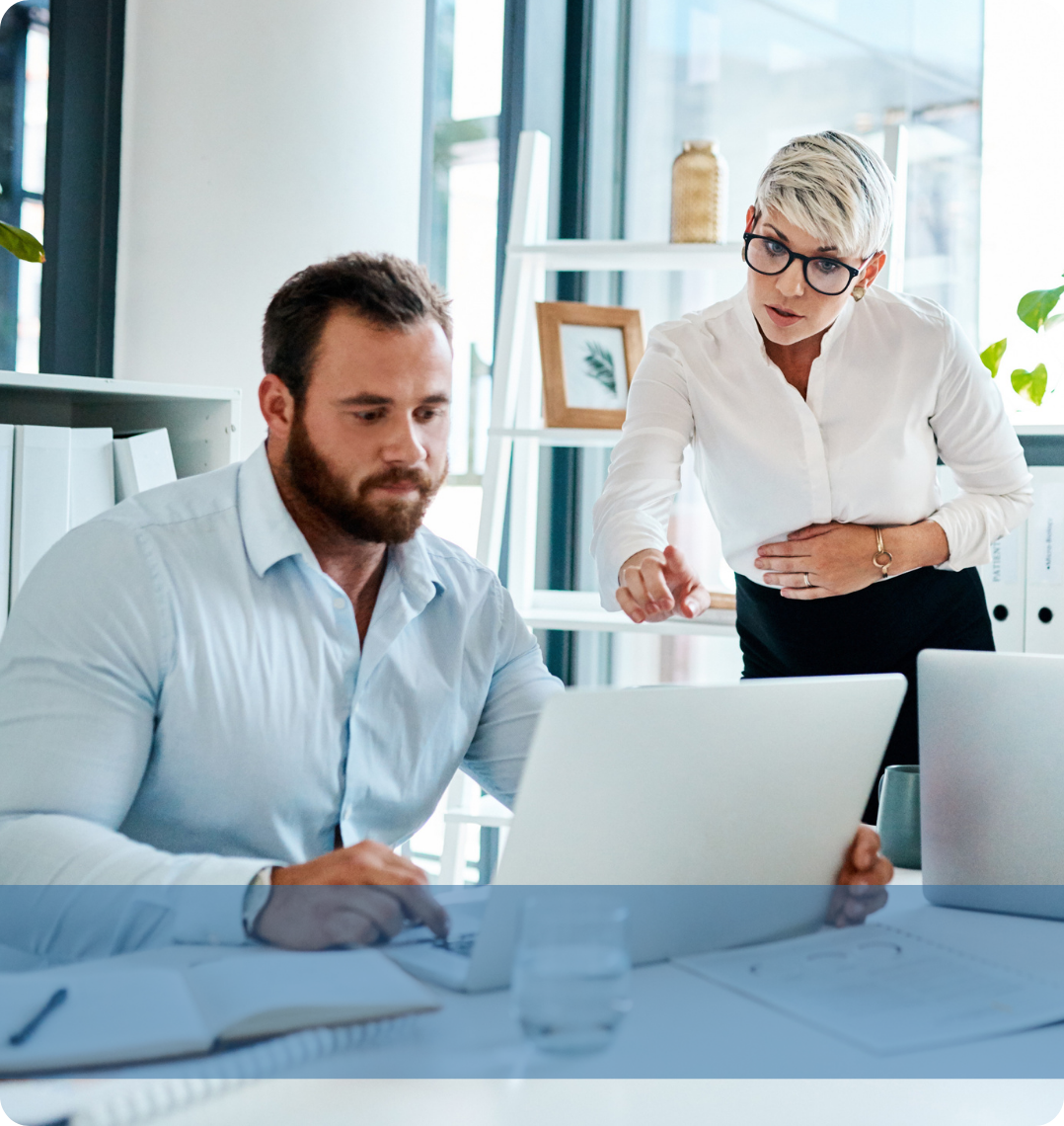Two professionals engaging in a discussion at a desk, representing the Konnekt IT recruitment team analysing technical candidate pipelines.